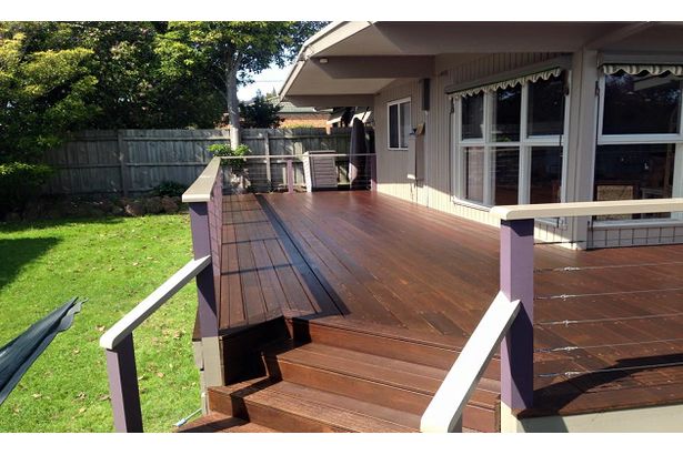 Newly stained deck outside of a house.